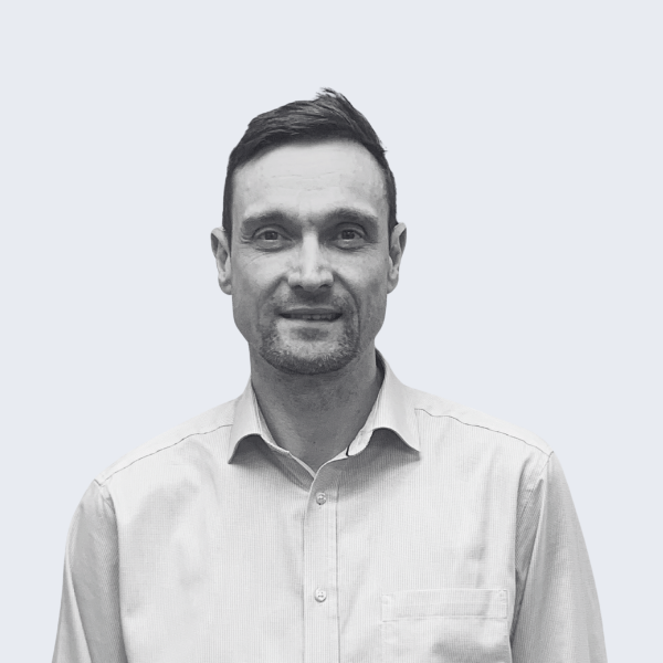 Photo shows a man with short, dark hair, in a light-coloured business shirt, smiling at the camera. Representing a recruitment agency near you, in Nuneaton.