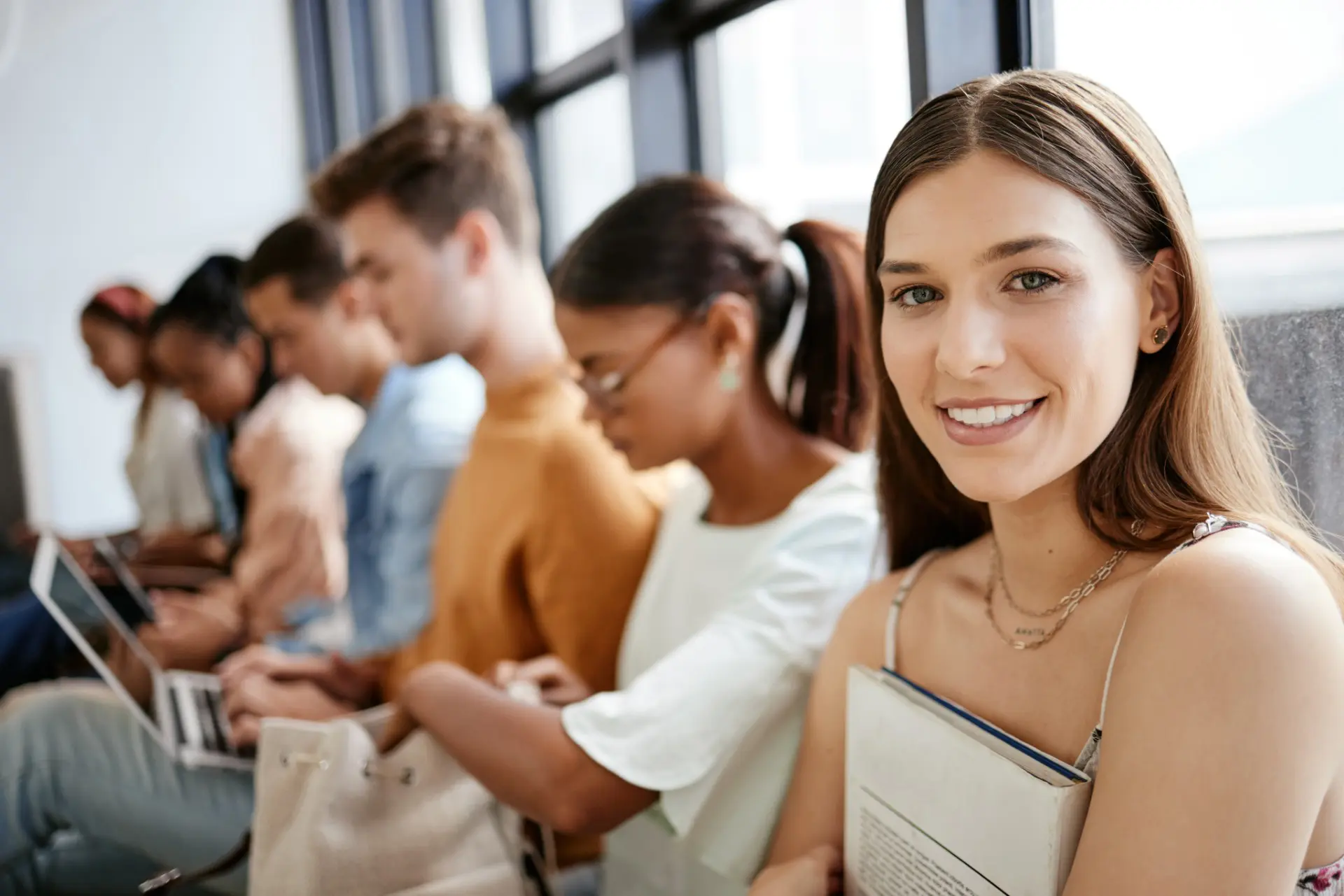Line of seated candidates with woman in foreground looking into camera smiling line of seated candidates with woman in foreground looking into camera smiling