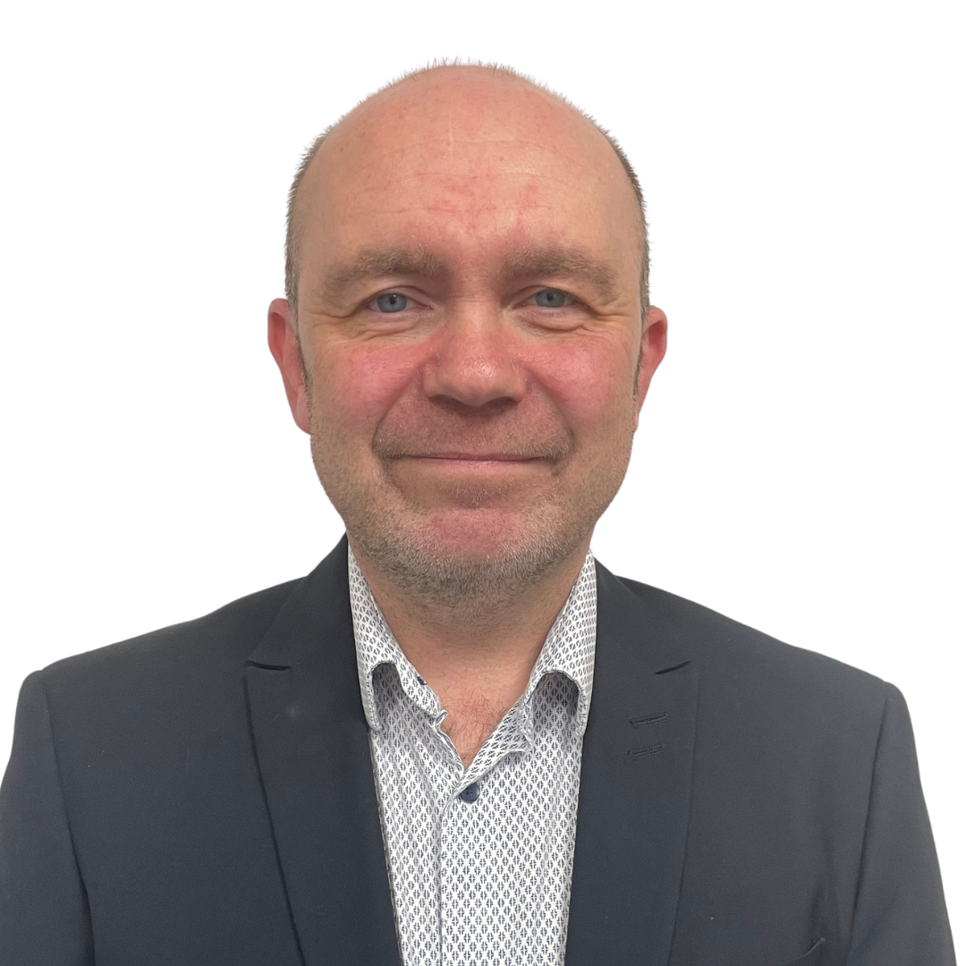 Warehouse worker standing in aisle arms crossed smiling to camera