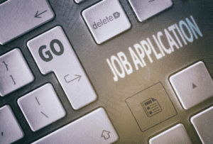 Close up of a laptop keyboard. Two buttons are labelled - 'Go' and 'Delete'. In the space between buttons are the words Job Application.